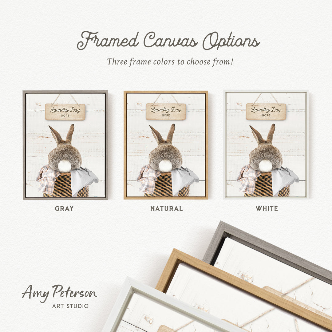 three framed canvas options for a laundry day theme, featuring a rabbit in a basket. The options include a gray frame, a natural frame, and a white frame.