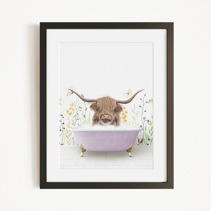A framed illustration depicting a Highland cow with large horns sitting in a purple bathtub, surrounded by flowers and plants.
