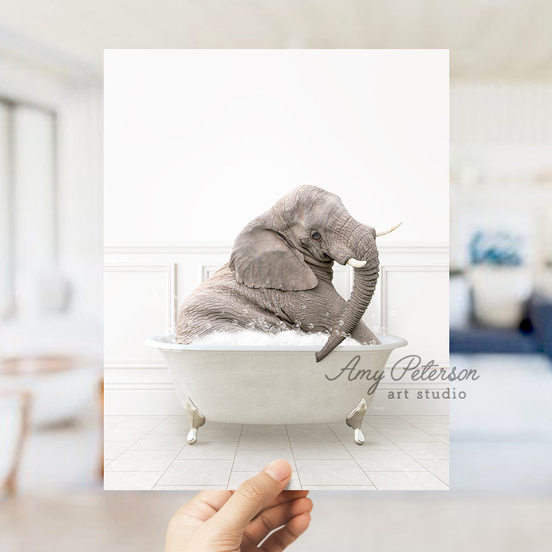 a person holding up a picture of an elephant in a bathtub