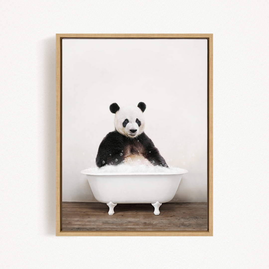 A panda bear sitting in a white bathtub filled with bubbles, looking directly at the camera.