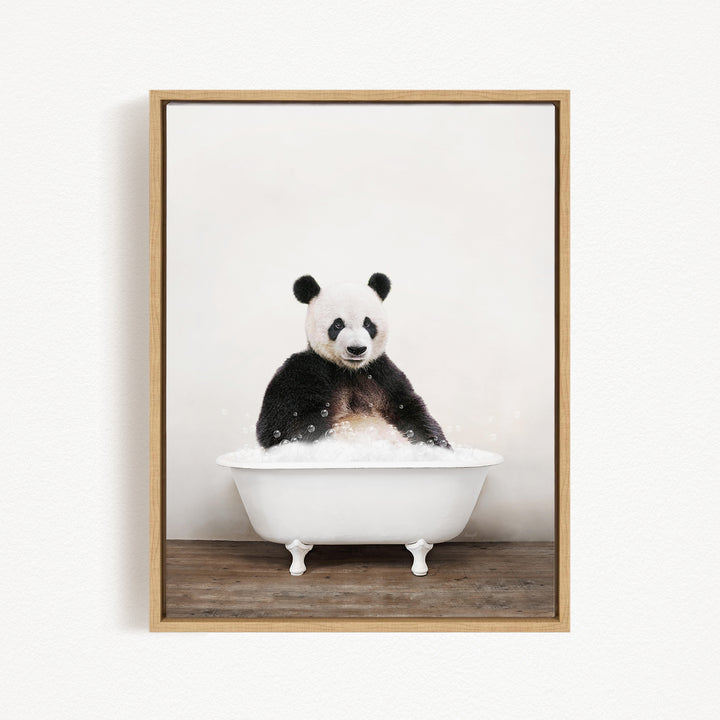 A panda bear sitting in a white bathtub filled with bubbles, looking directly at the camera.