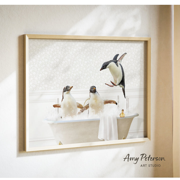 A framed photograph of three penguins sitting in a bathtub, with one penguin standing on its hind legs and another sitting on its belly.