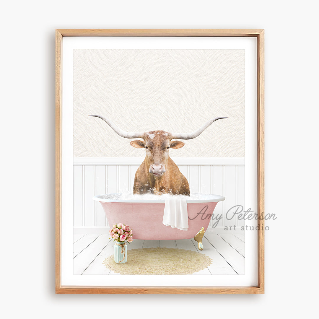 a cow with long horns is sitting in a bathtub