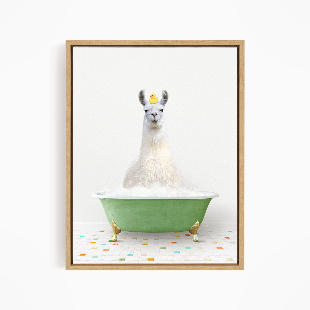 A white llama sitting in a green bathtub filled with bubbles, with a yellow rubber duck floating on its head.