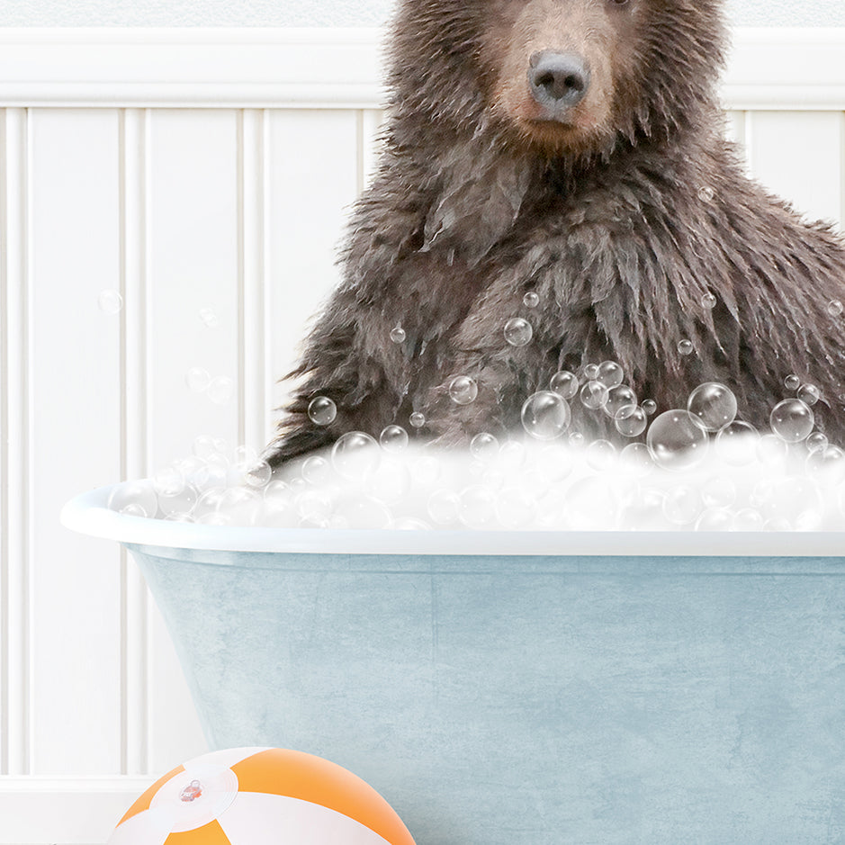 a brown bear sitting in a bathtub with bubbles