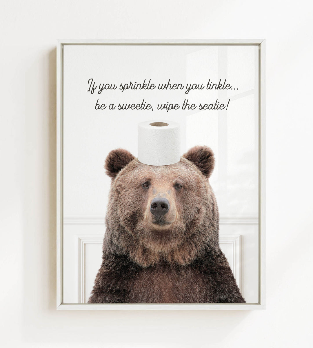 A brown bear sitting on a roll of toilet paper with a humorous caption above it.