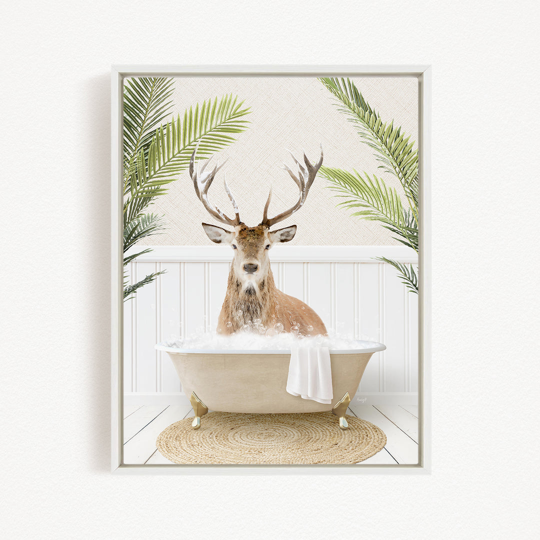 A deer with antlers is sitting in a bathtub filled with bubbles, surrounded by green palm fronds.