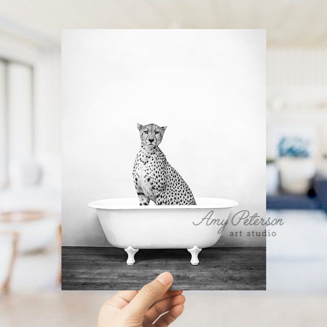 a black and white photo of a cheetah sitting in a bathtub