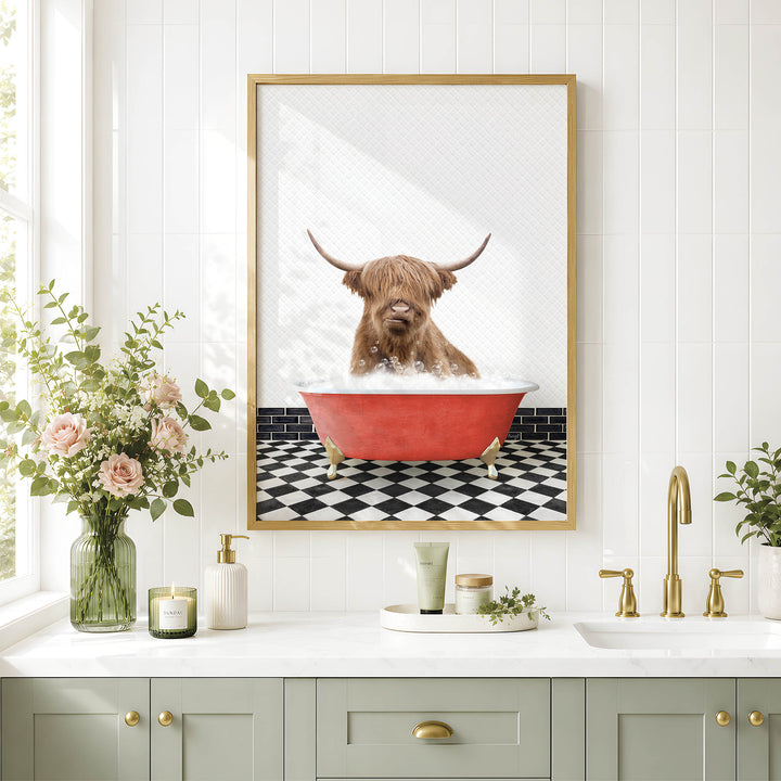 a bathroom with a framed picture of a Highland cow sitting in a red bathtub, surrounded by flowers and greenery.