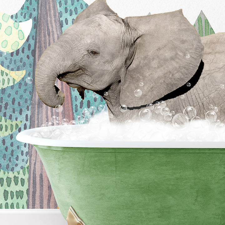 a baby elephant taking a bath in a green tub