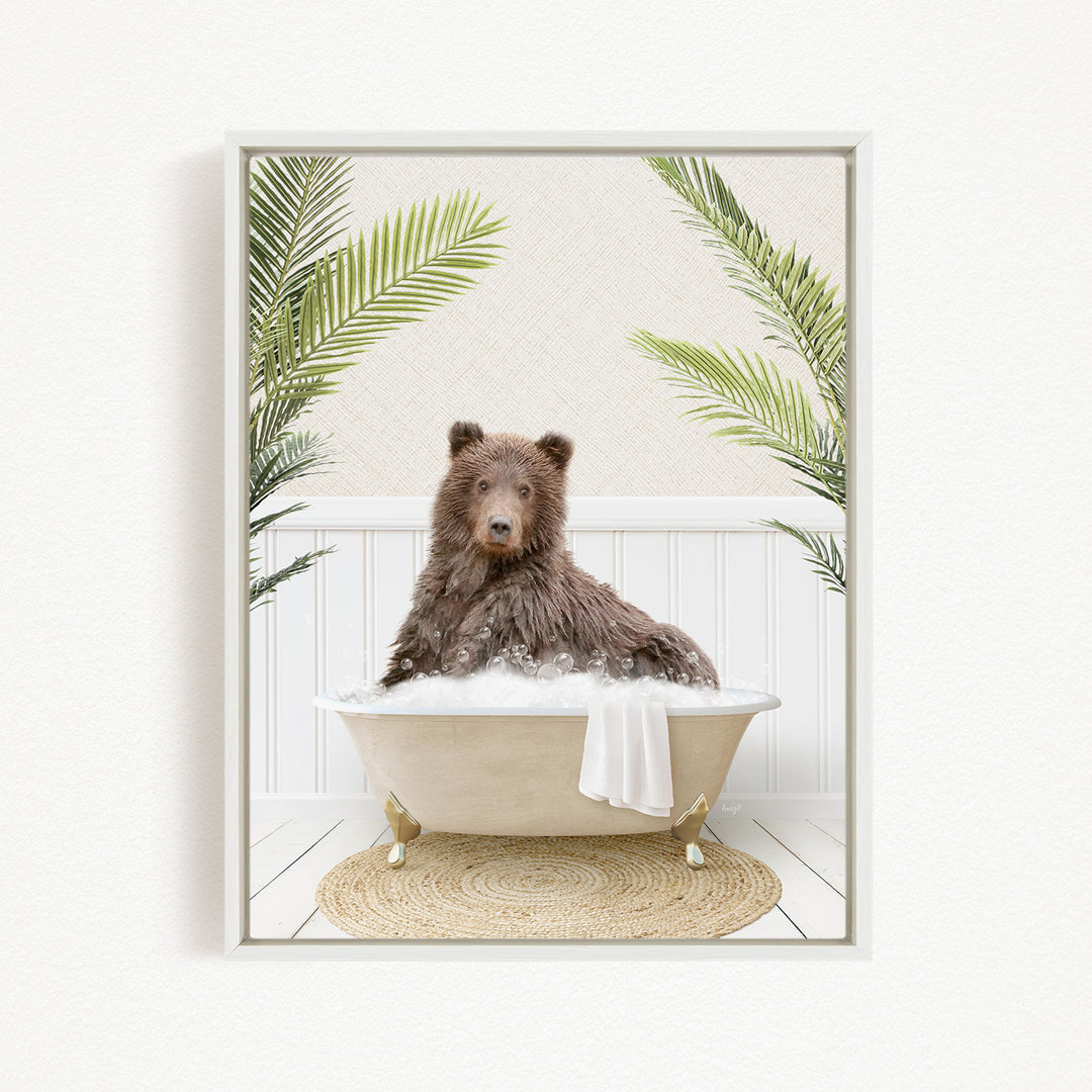 A brown bear sitting in a bathtub filled with water, surrounded by green palm leaves.