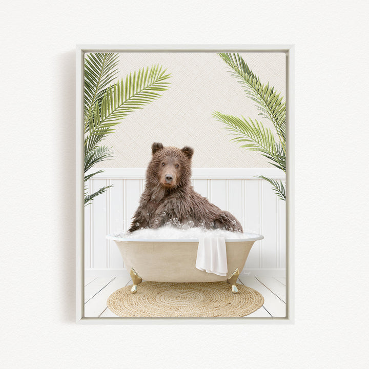 A brown bear sitting in a bathtub filled with water, surrounded by green palm leaves.
