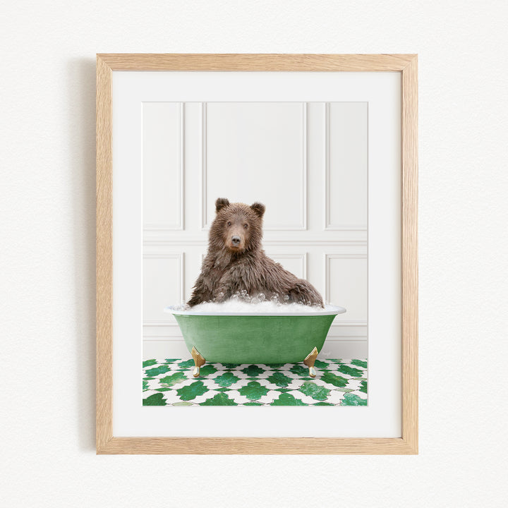 A brown bear sitting in a green bathtub filled with water, surrounded by a green and white patterned rug.