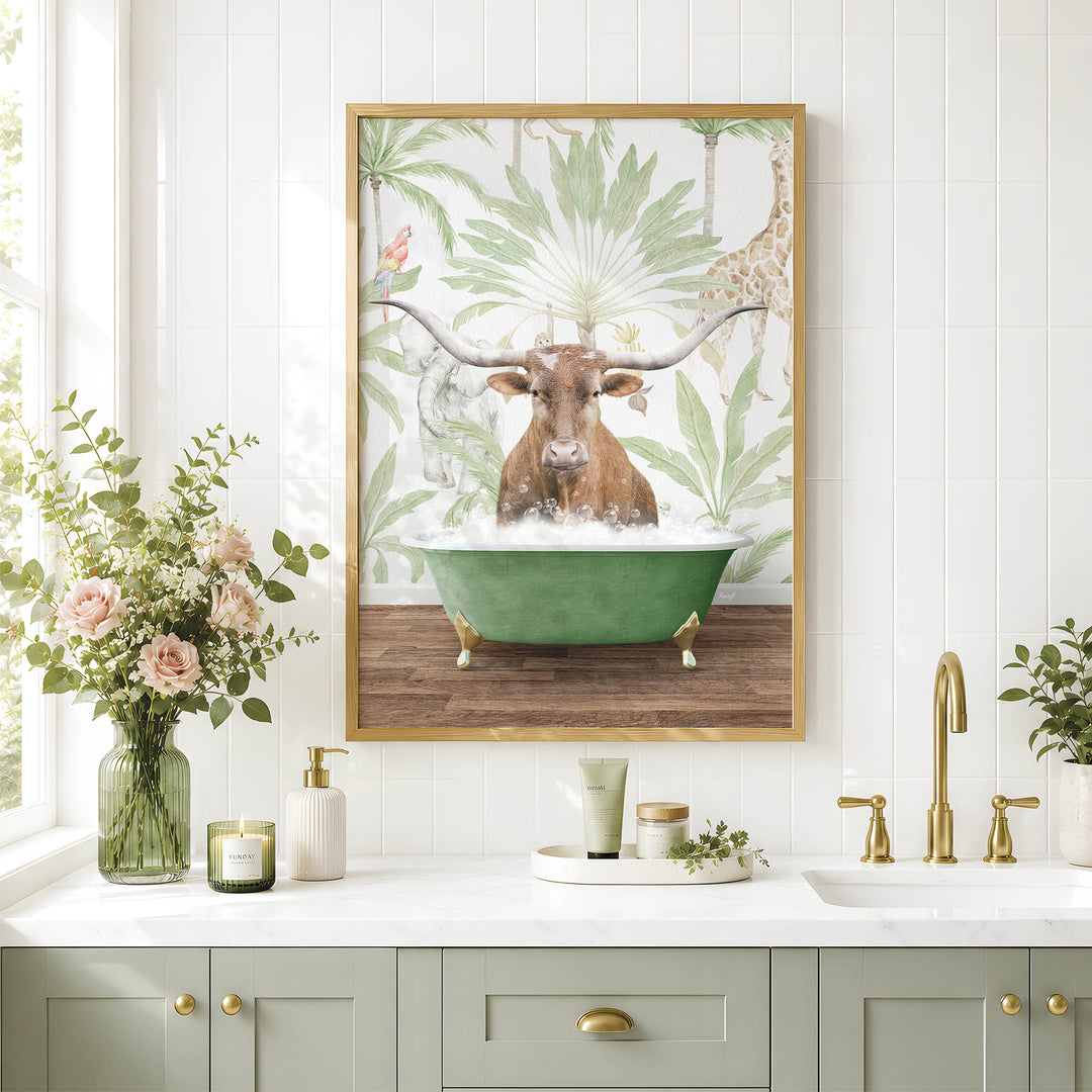 a bathroom scene with a framed picture of a bull with horns sitting in a bathtub, surrounded by tropical foliage. The bathroom counter has various toiletries and decorative items, including a vase with flowers, a candle, and a small plant.