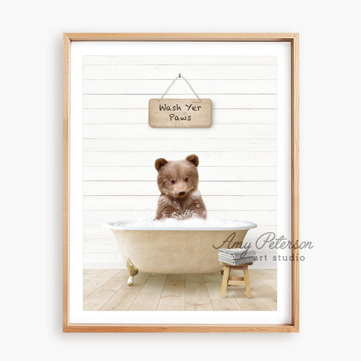 a brown teddy bear sitting in a bath tub