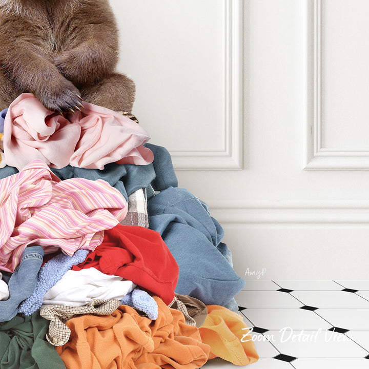 A pile of clothes, including various garments in different colors and styles, is stacked on a white floor against a white wall.