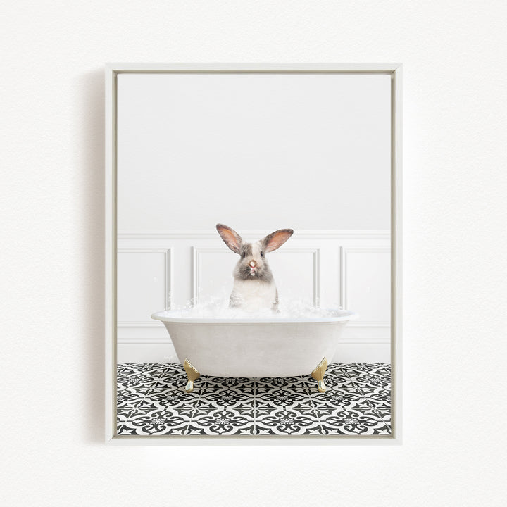 A white rabbit sitting in a white bathtub filled with water, surrounded by a black and white patterned floor.