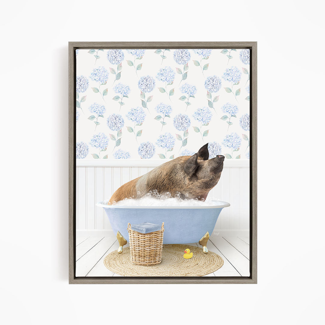A pig sitting in a blue bathtub filled with bubbles, surrounded by a wicker basket and yellow rubber ducks.