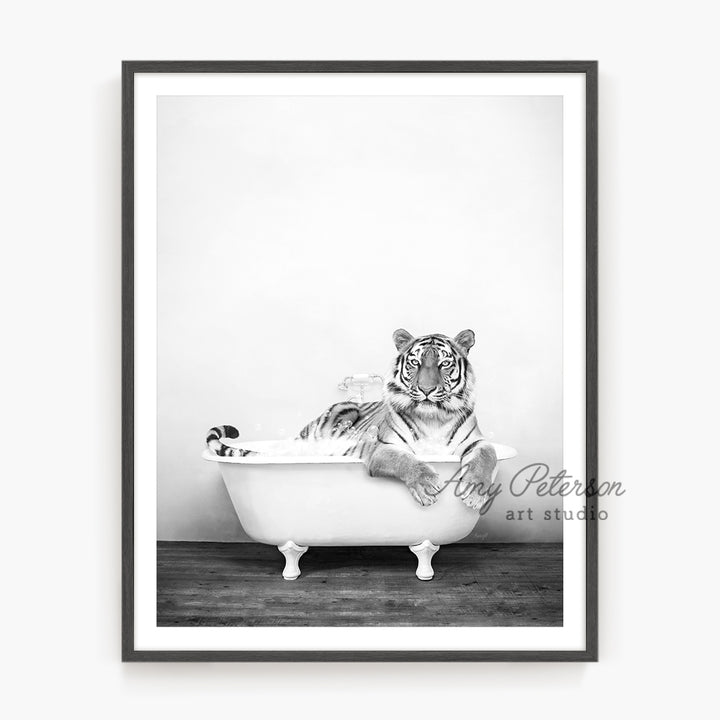 a black and white photo of a tiger in a bathtub