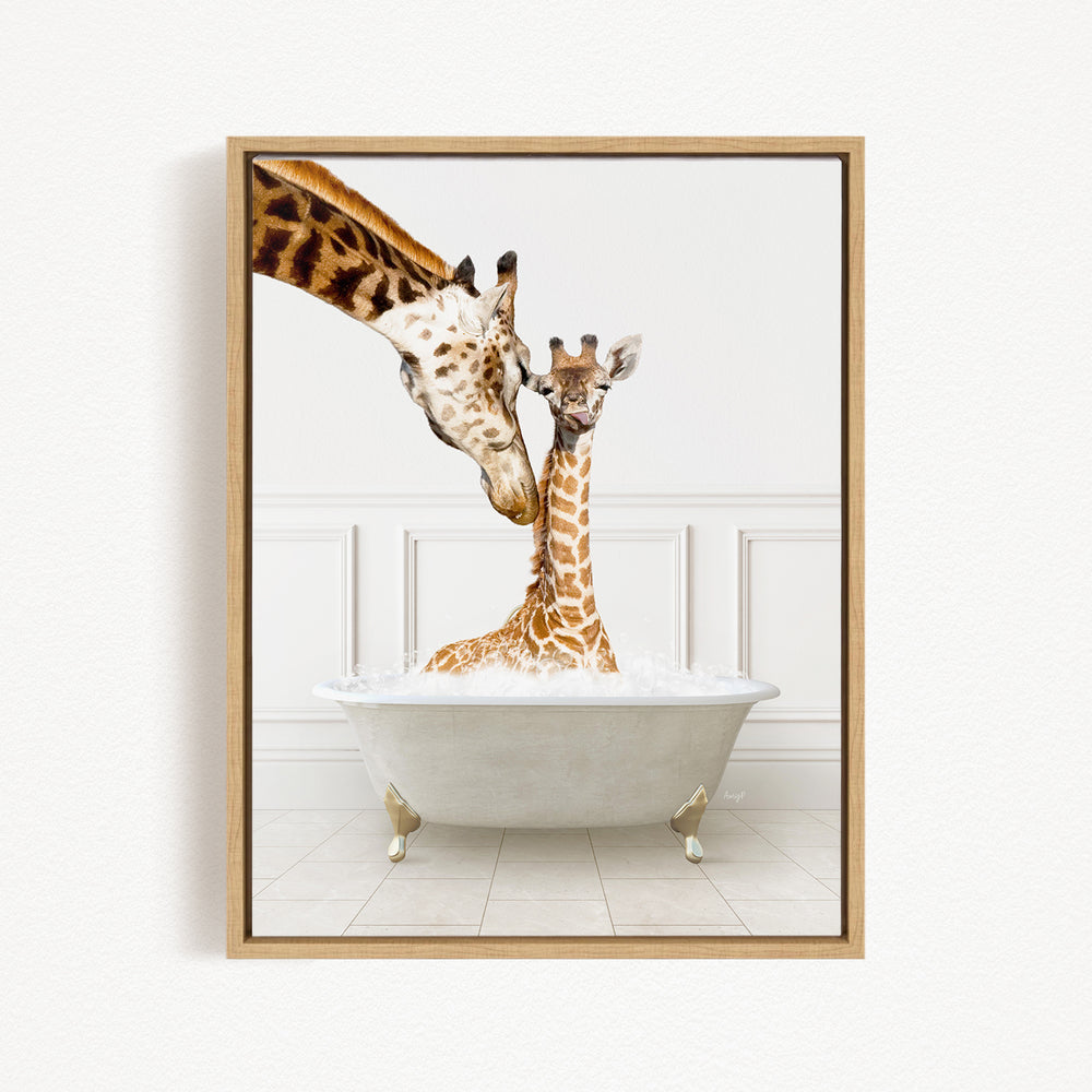 A mother giraffe and her baby giraffe are sitting together in a white bathtub, with the mother gently licking her baby.