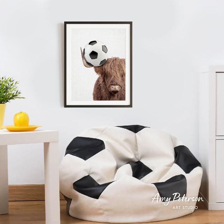 a framed picture of a brown cow with horns, which is hanging on a wall above a white bean bag chair.