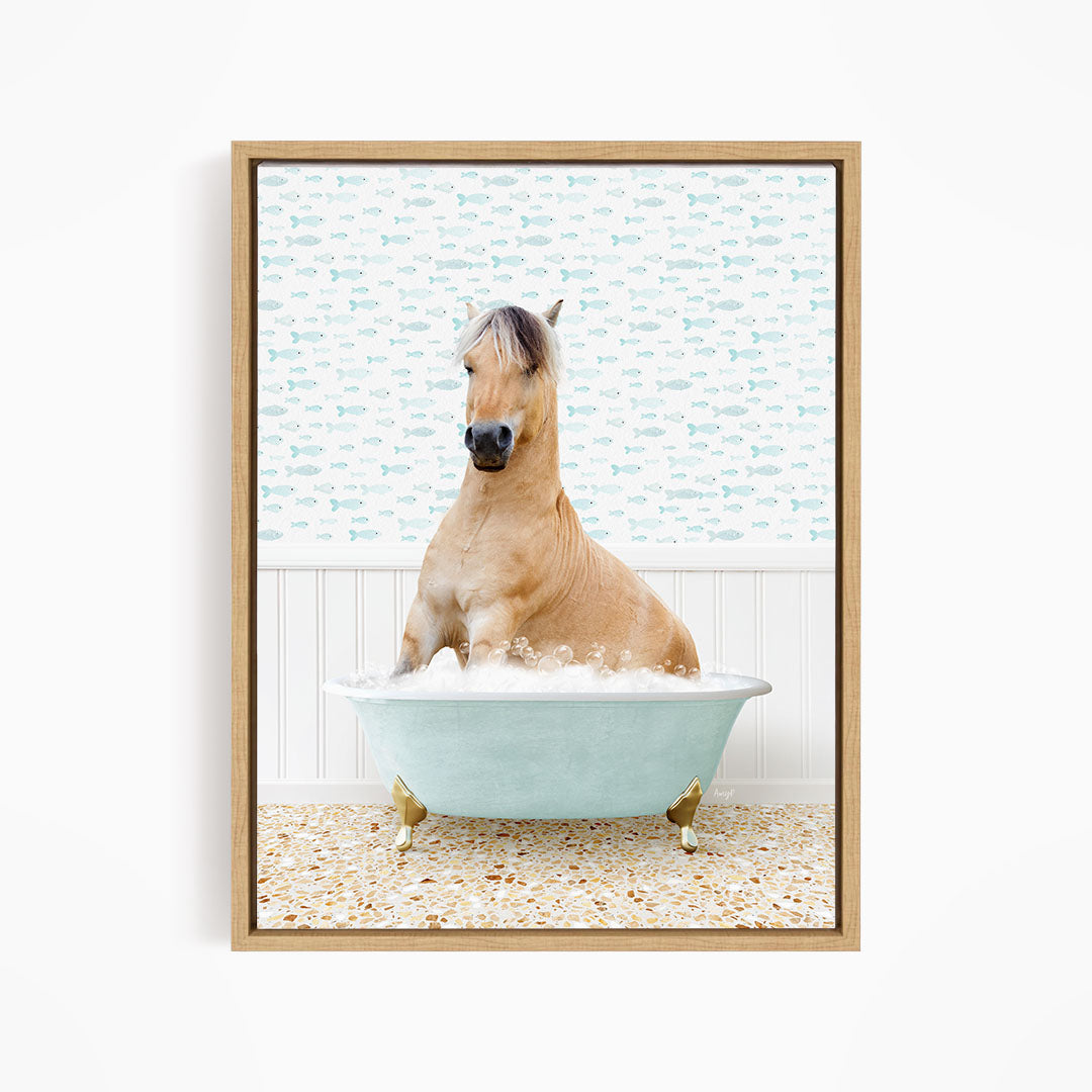 A light brown horse is sitting in a blue bathtub filled with water, surrounded by a pattern of small fish.