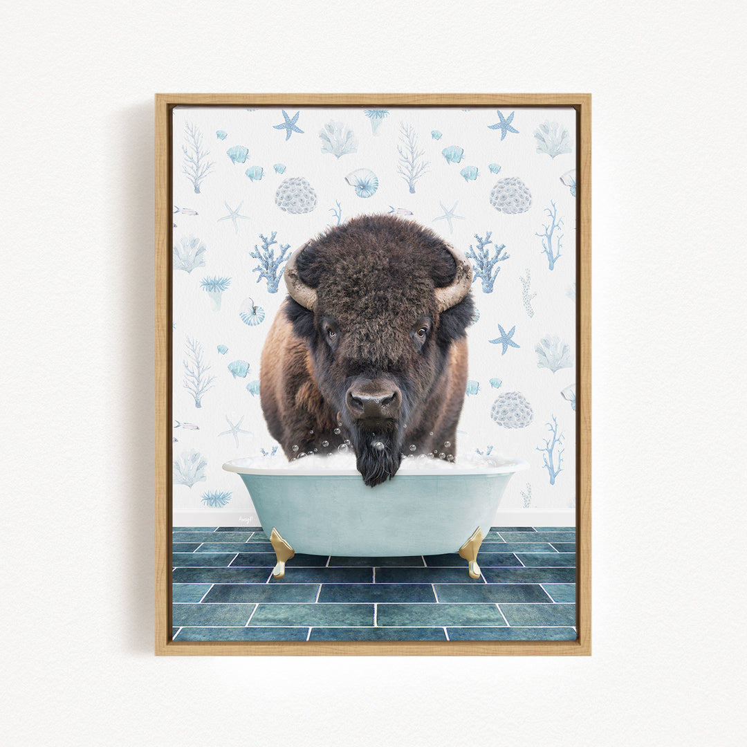 A buffalo is sitting in a bathtub filled with water, surrounded by blue and white floral patterns on the wall behind it.