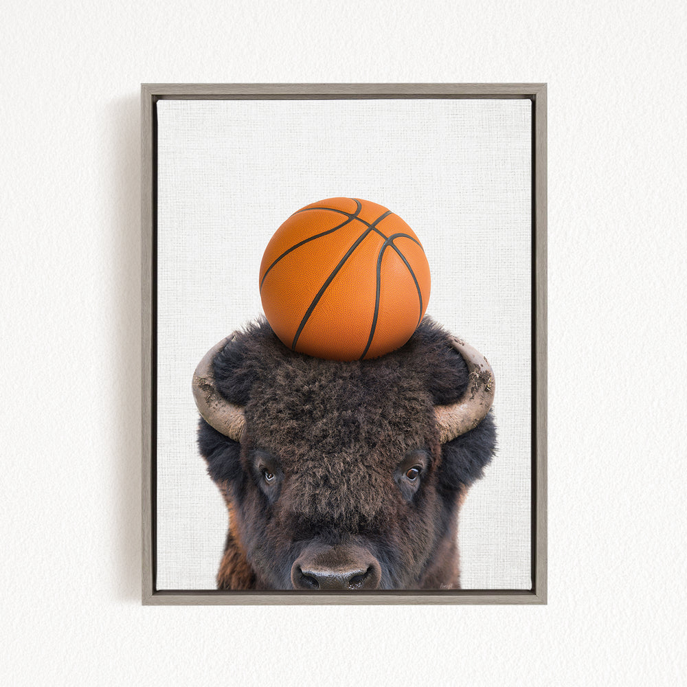 A buffalo with a basketball on its head is the main subject of the image.