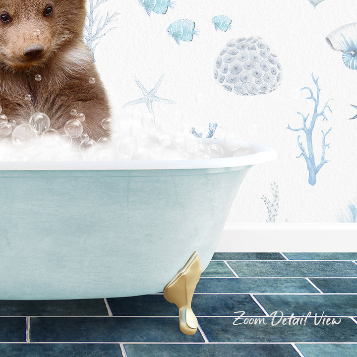 A brown bear is sitting in a blue bathtub filled with bubbles, surrounded by a wallpaper with marine life and starfish designs.