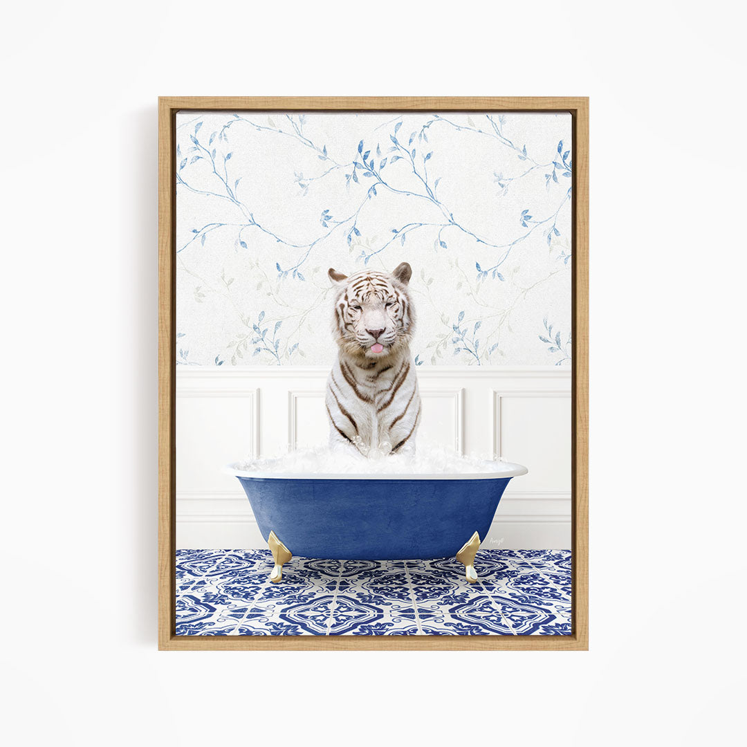 A white tiger is sitting in a blue bathtub filled with water, surrounded by a blue and white patterned rug on the floor.