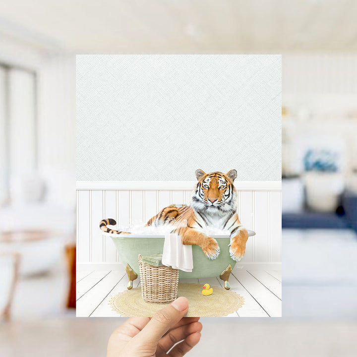 A tiger is sitting in a bathtub filled with water, surrounded by a basket and a rubber duck.
