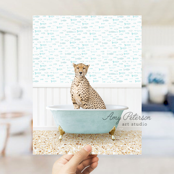 a cheetah sitting in a blue bath tub