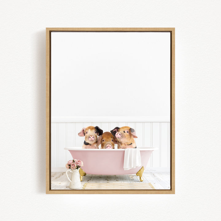 Three adorable pigs sitting in a pink bathtub, surrounded by flowers and a white vase.