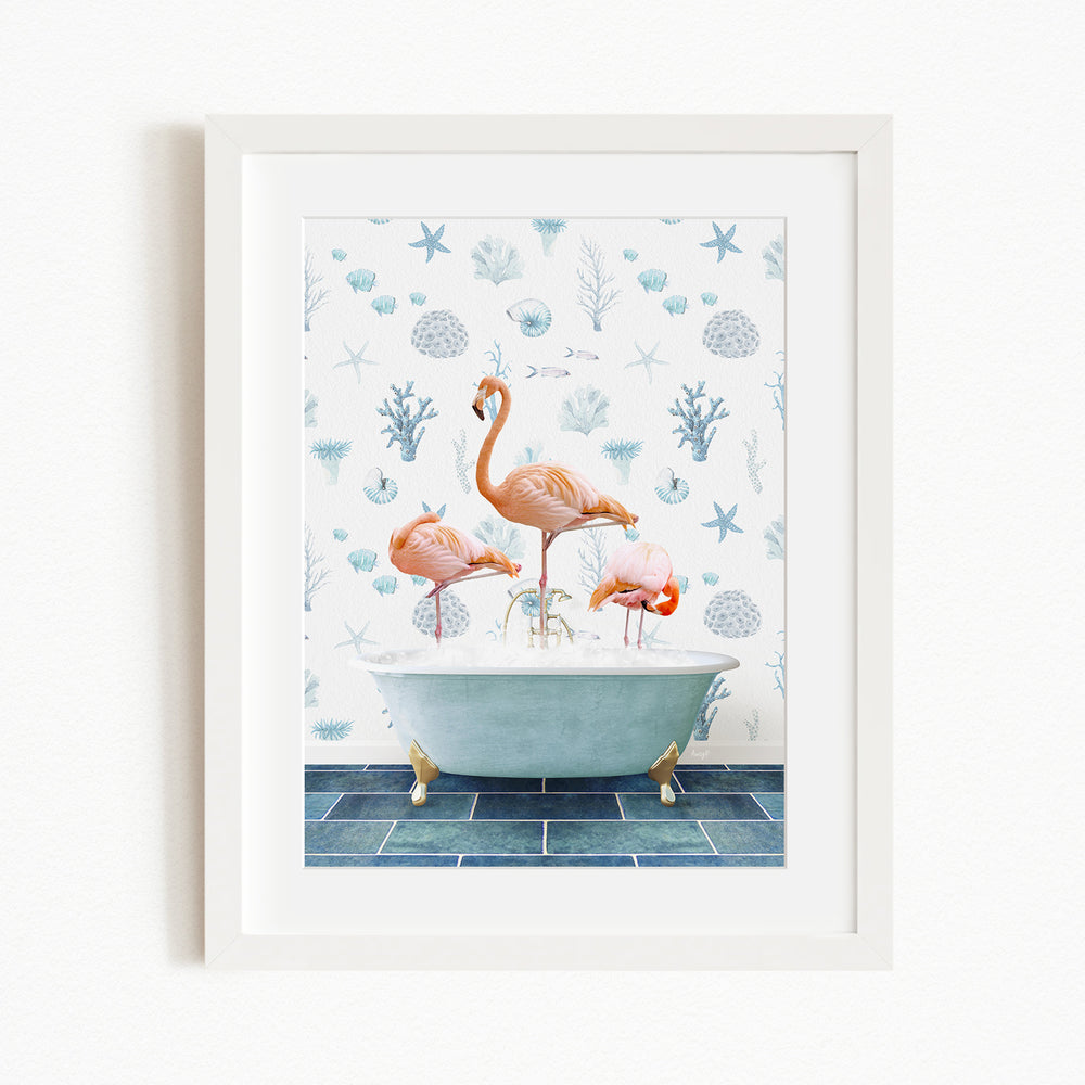 A framed image depicting three flamingos standing in a bathtub filled with water, surrounded by a blue and white floral pattern.