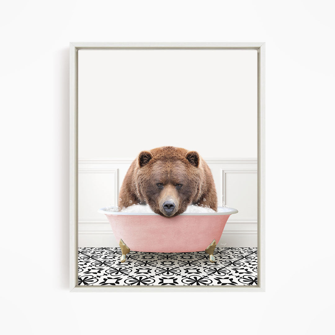 A brown bear is sitting in a pink bathtub filled with water, appearing to be enjoying a relaxing bath.