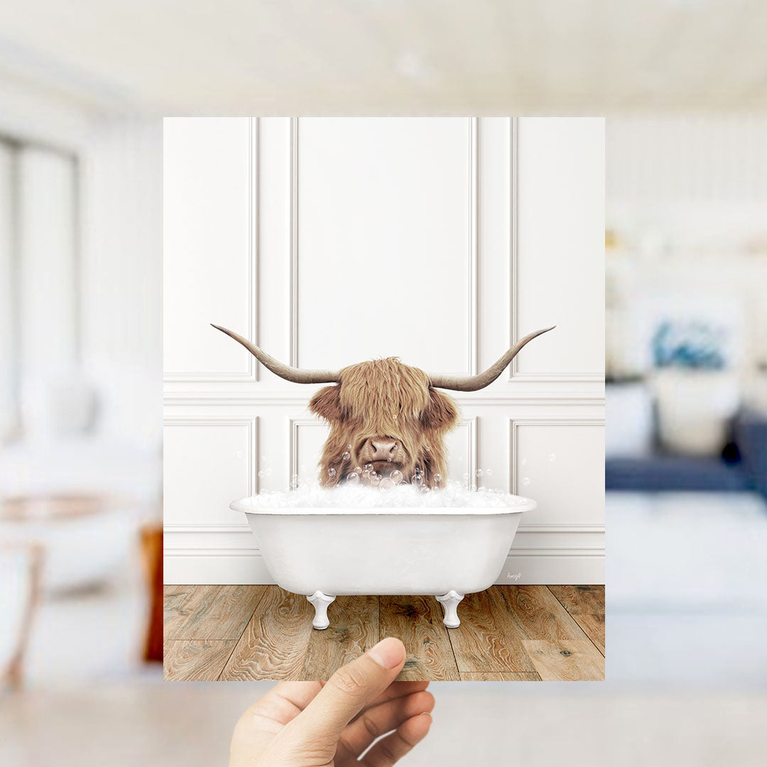 A Highland cow with large curved horns is sitting in a white bathtub filled with water, creating a whimsical and playful scene.