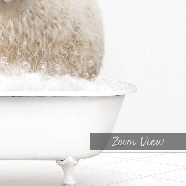 A fluffy white dog is sitting in a white bathtub filled with bubbles, creating a playful and adorable scene.