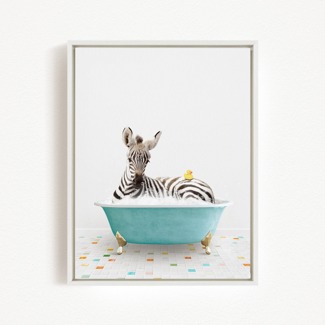 A zebra is sitting in a blue bathtub, with a yellow rubber duck floating on the water.