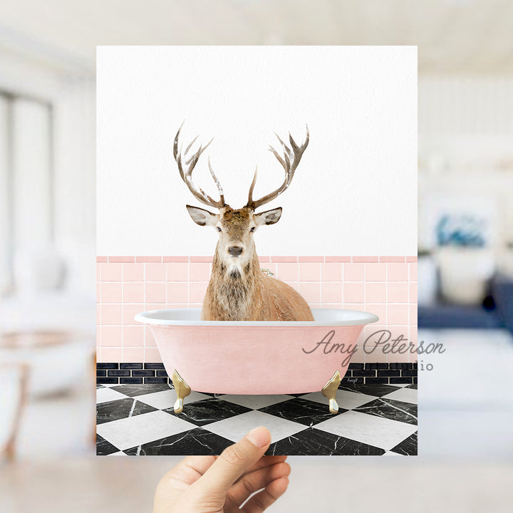 a person holding up a card with a picture of a deer in a bathtub