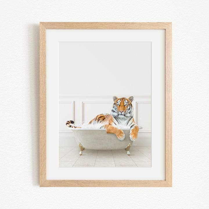 A tiger is sitting in a bathtub, appearing relaxed and comfortable.