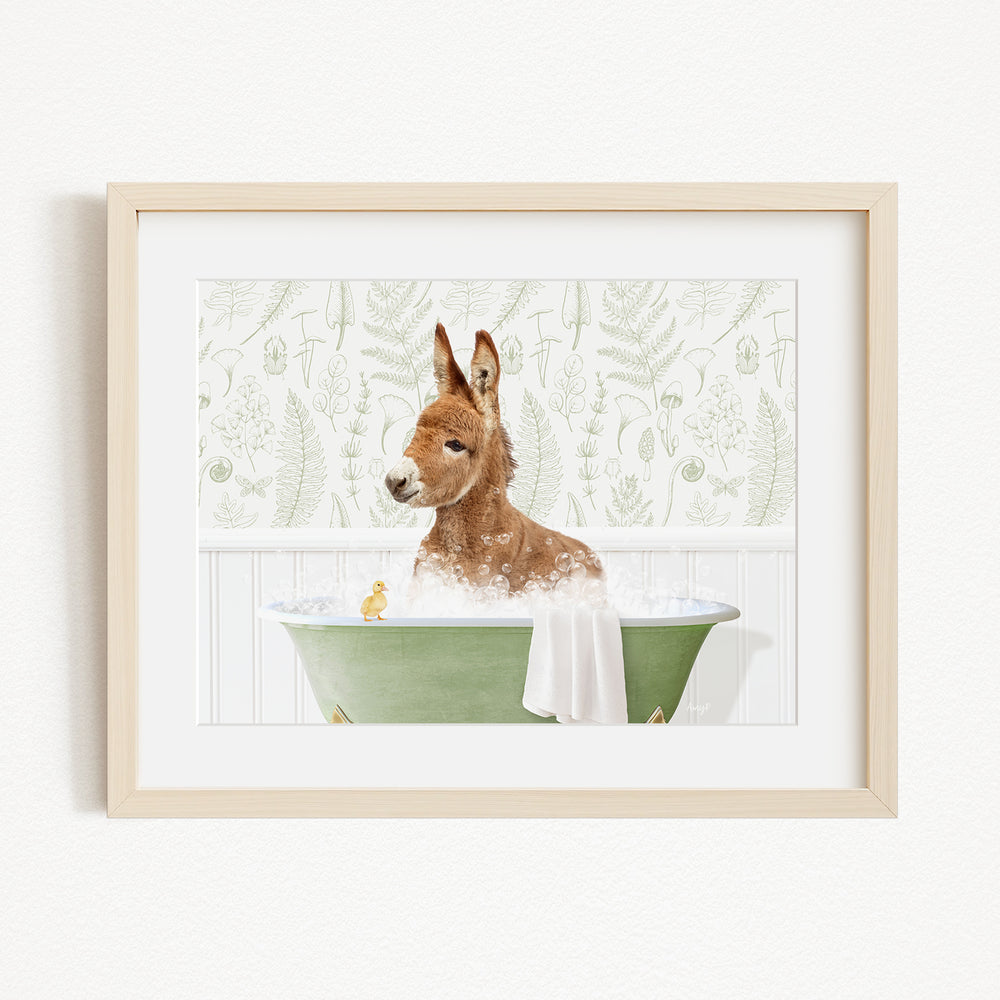 A brown dog is sitting in a green bathtub filled with bubbles, with a yellow duck floating nearby.