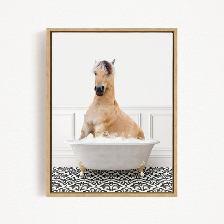 A light brown horse is sitting in a white bathtub filled with bubbles, creating a whimsical and playful scene.