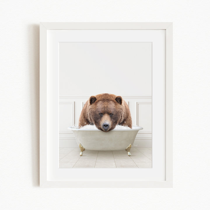 A brown bear is sitting in a white bathtub, appearing to be enjoying a relaxing bath.