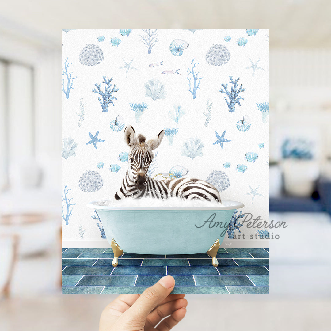 a hand holding up a photo of a zebra in a bathtub