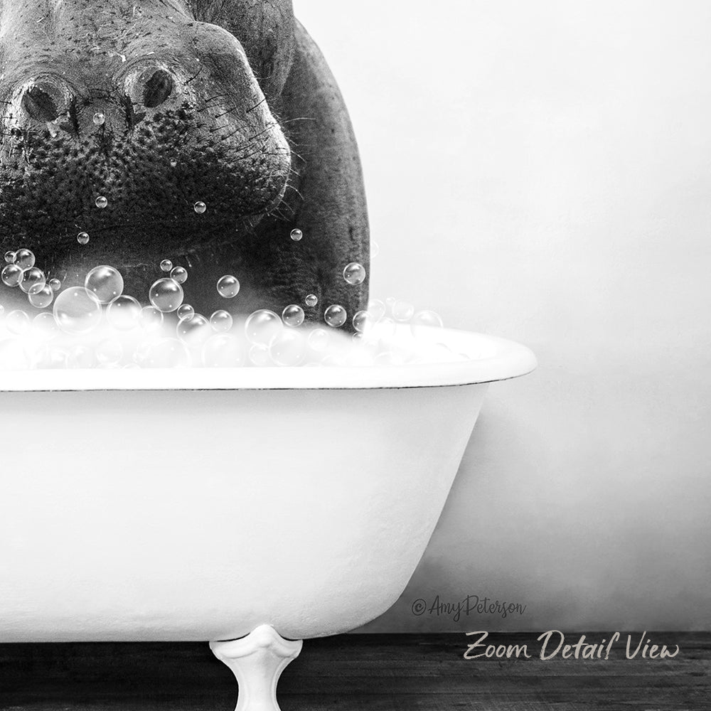A close-up black and white image of a hippopotamus submerged in a bathtub filled with bubbles.