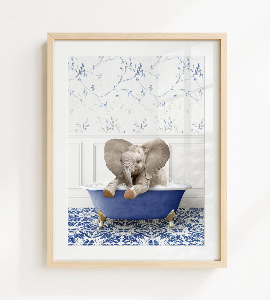 A baby elephant sitting in a blue bathtub filled with water, surrounded by a blue and white patterned floor.