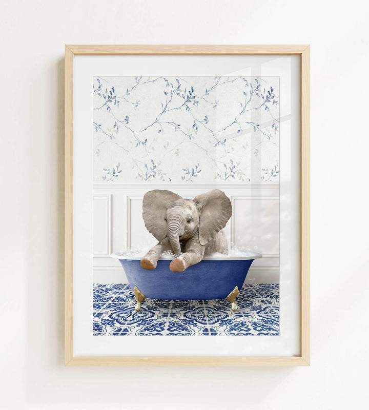 A baby elephant sitting in a blue bathtub filled with water, surrounded by a blue and white patterned floor.