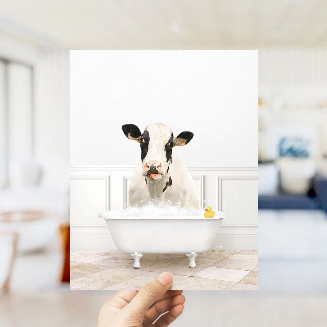 A cow is sitting in a bathtub filled with water, with a rubber duck floating nearby.