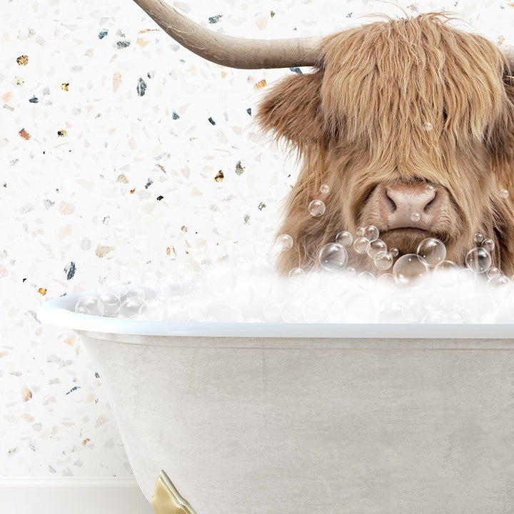 a bull with long horns sitting in a bathtub filled with bubbles