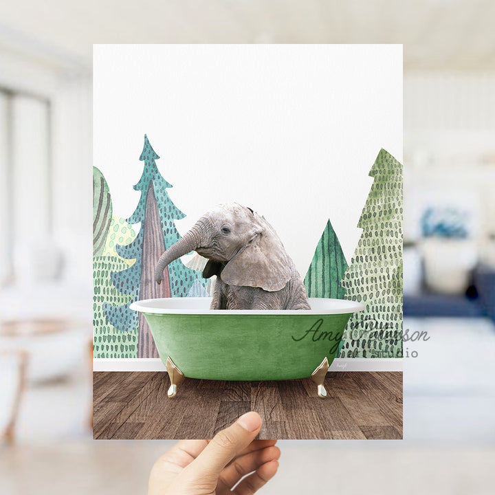 a hand holding up a picture of an elephant in a bathtub